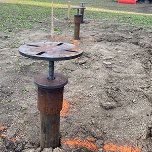 Adjustable screw pile cap installed for a deck